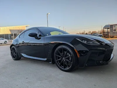 Black Toyota GR86 with a glossy finish at sunset