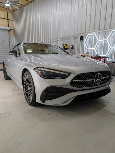 White Mercedes-Benz coupe under hexagon studio lights